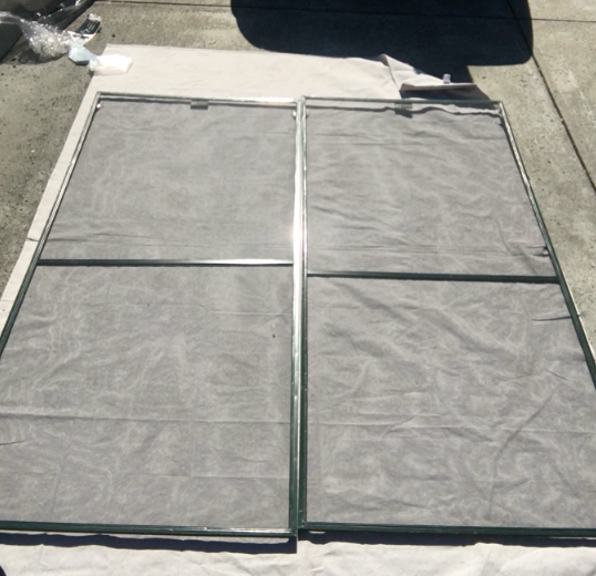 Two sliding door screens — re-screened and ready